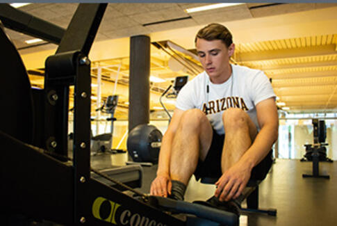 Male student using exercise equipment